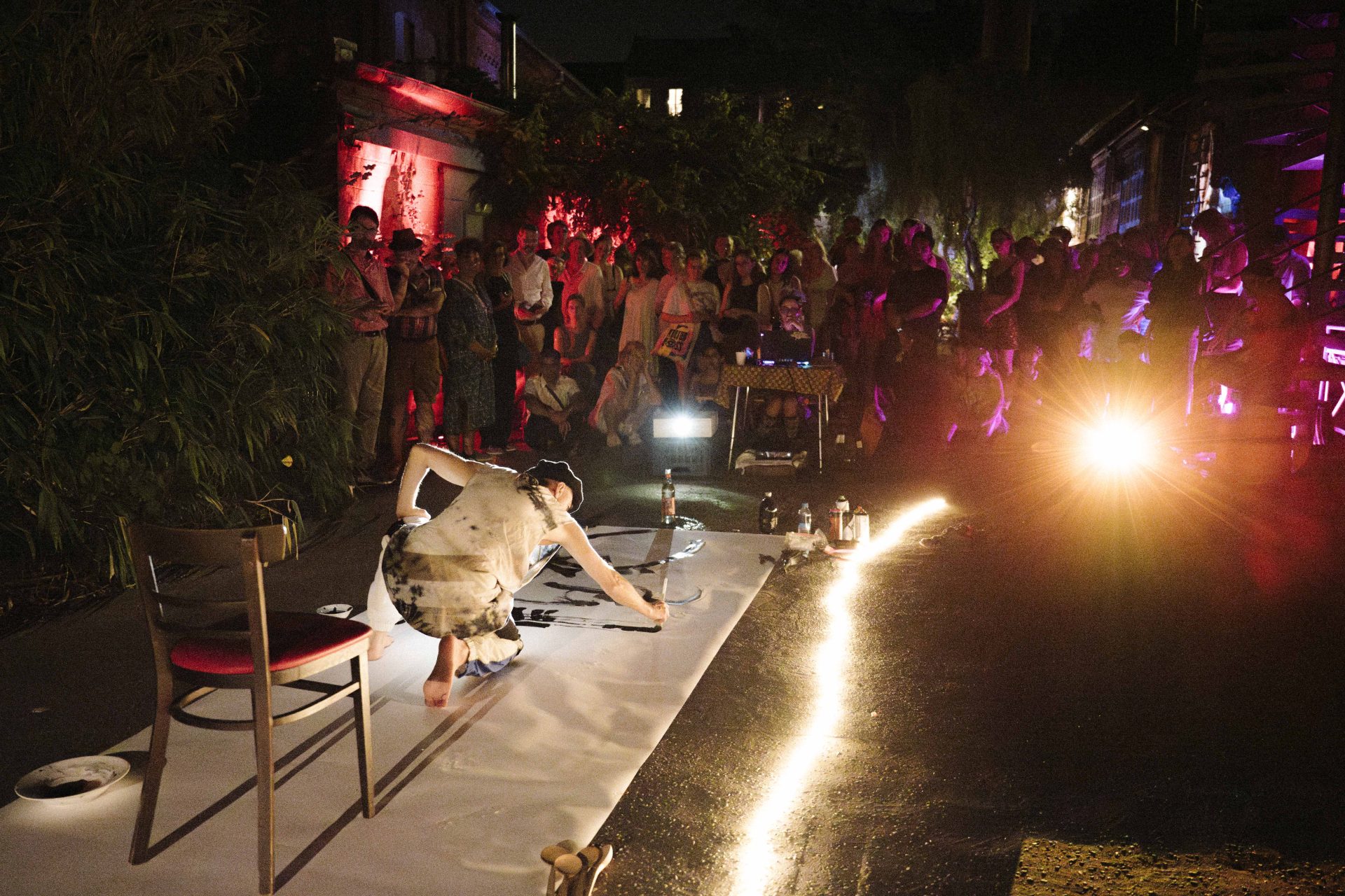 Choreographer and calligrapher Kadir Amigo Memis performs in the illuminated courtyard of the Kurt Mühlenhaupt Museum at night