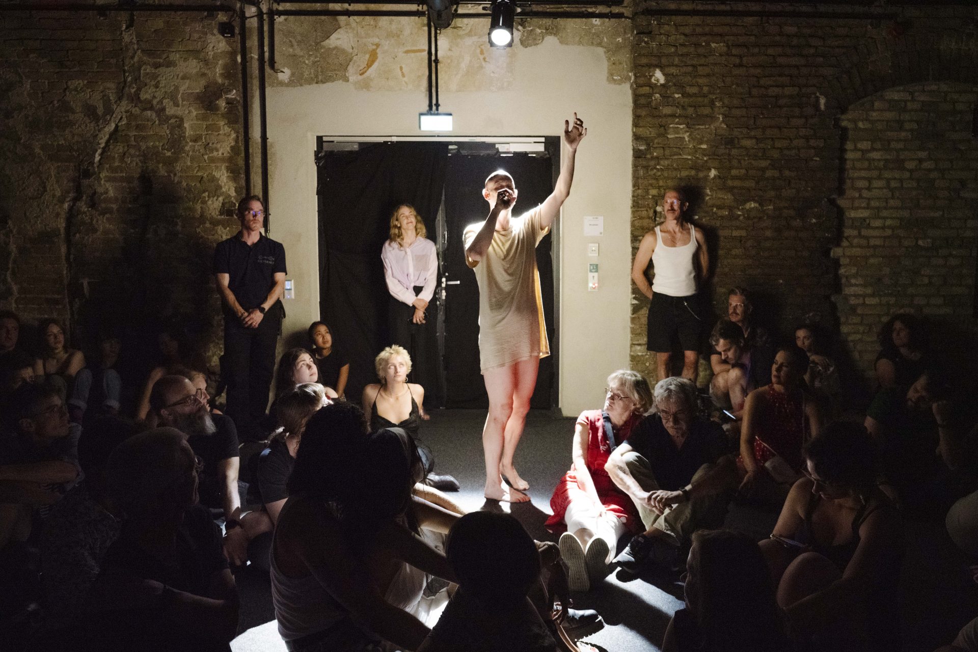 Performer Damian Rebgetz sings in the Museum of Medical History surrounded by numerous spectators